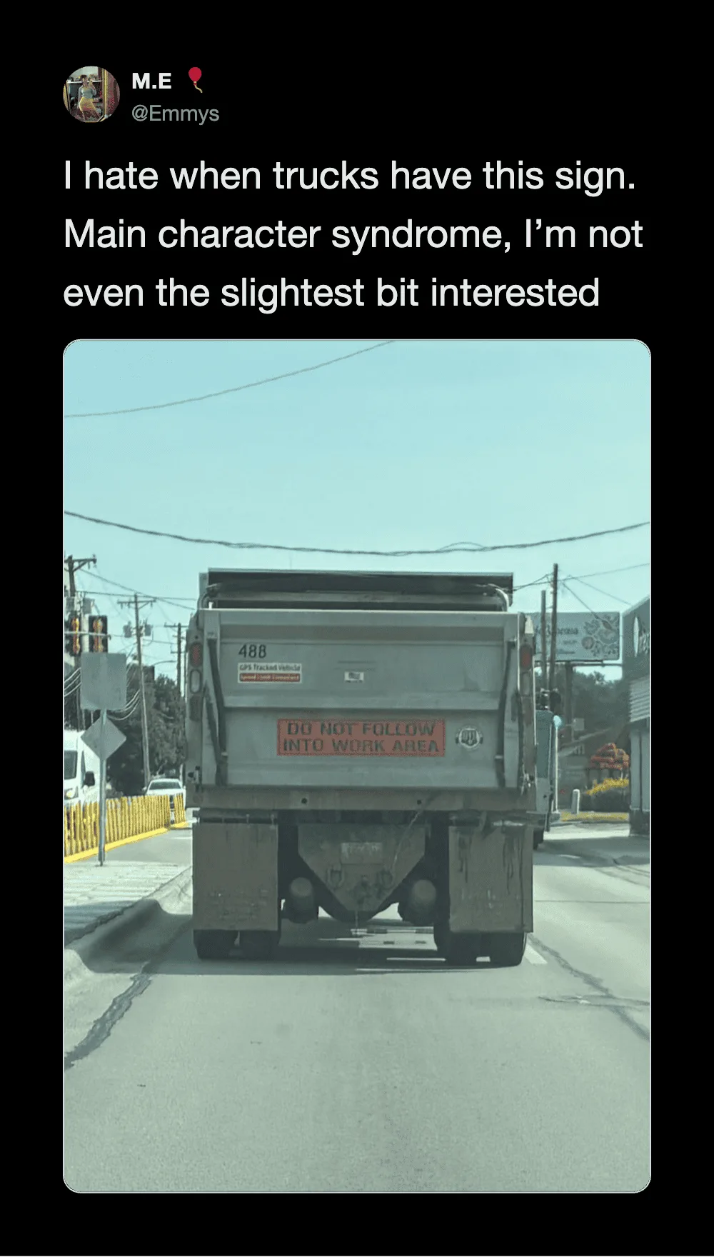 Truck with a sign that says 'DO NOT FOLLOW INTO WORK AREA' on the back.