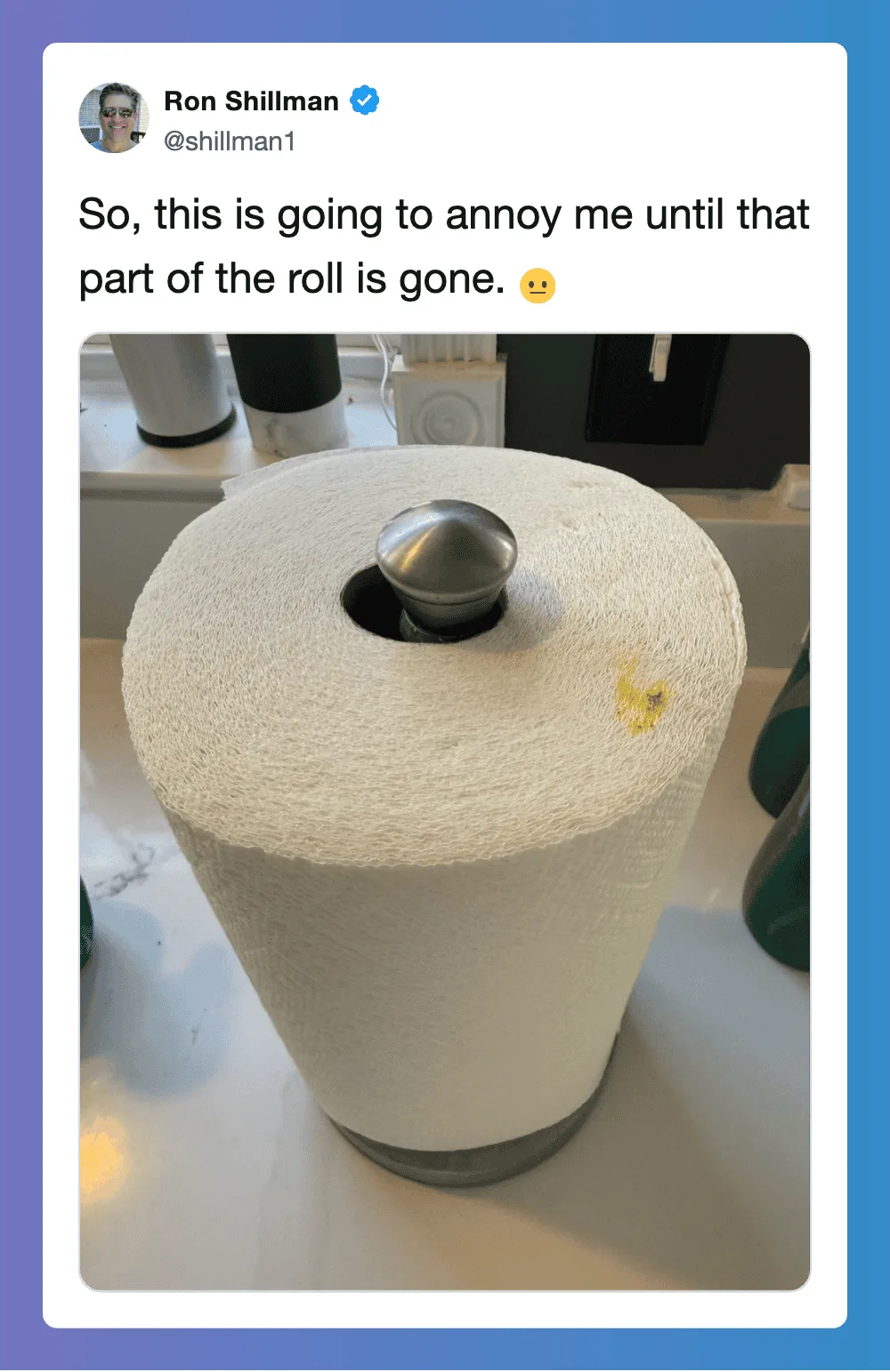 A roll of paper towel with a metal ball on top, part of the roll is missing.