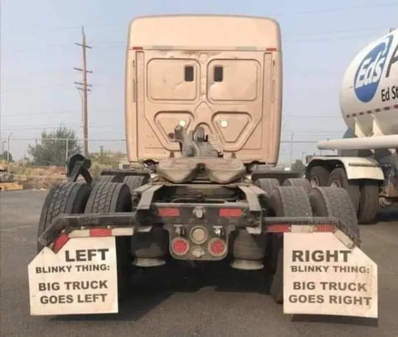 Humorous truck signs: 'Left blinky thing: big truck goes left' and 'Right blinky thing: big truck go.