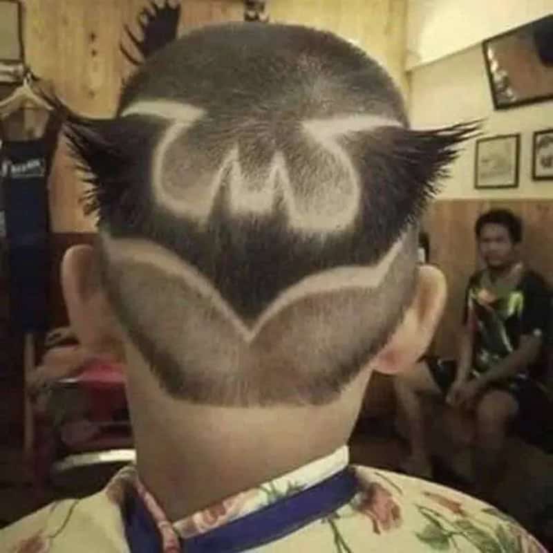 Child with a Batman logo shaved into the back of their head.