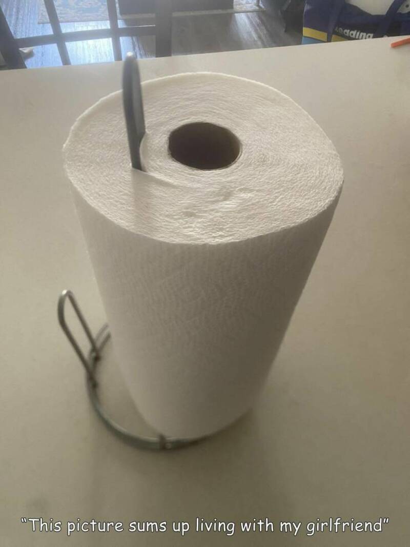 Toilet paper roll with a knife stuck in the center, resembling a toilet.