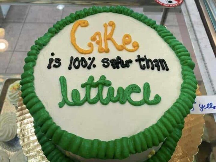 Cake with green border and message: 'Cake is 100% better than lettuce'.