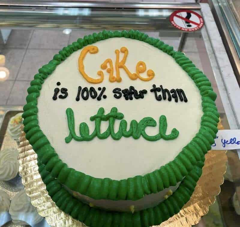 Cake with green border and message: 'Cake is 100% better than lettuce'.