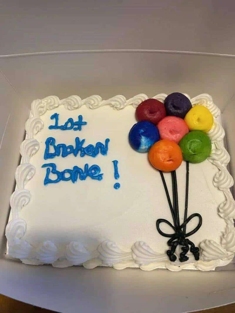 Cake with colorful balloons and the text 'Lost Broken Bone!'.