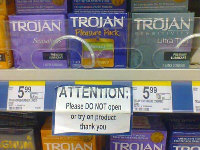 Sign on store shelf says 'ATTENTION: Please DO NOT open or try on product thank you'.