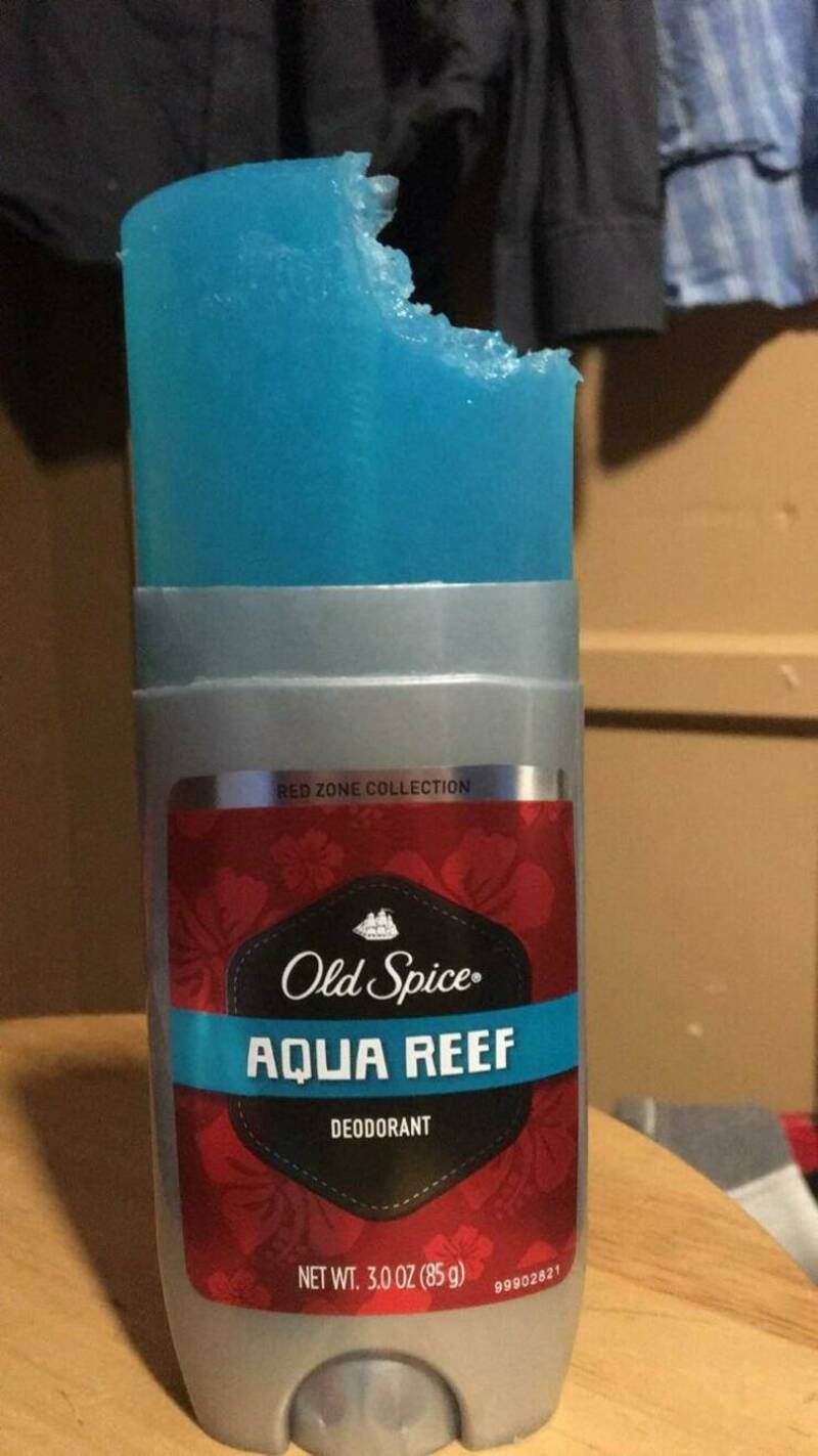 Old Spice Aqua Reef deodorant with a bitten top, blue color, and red label.