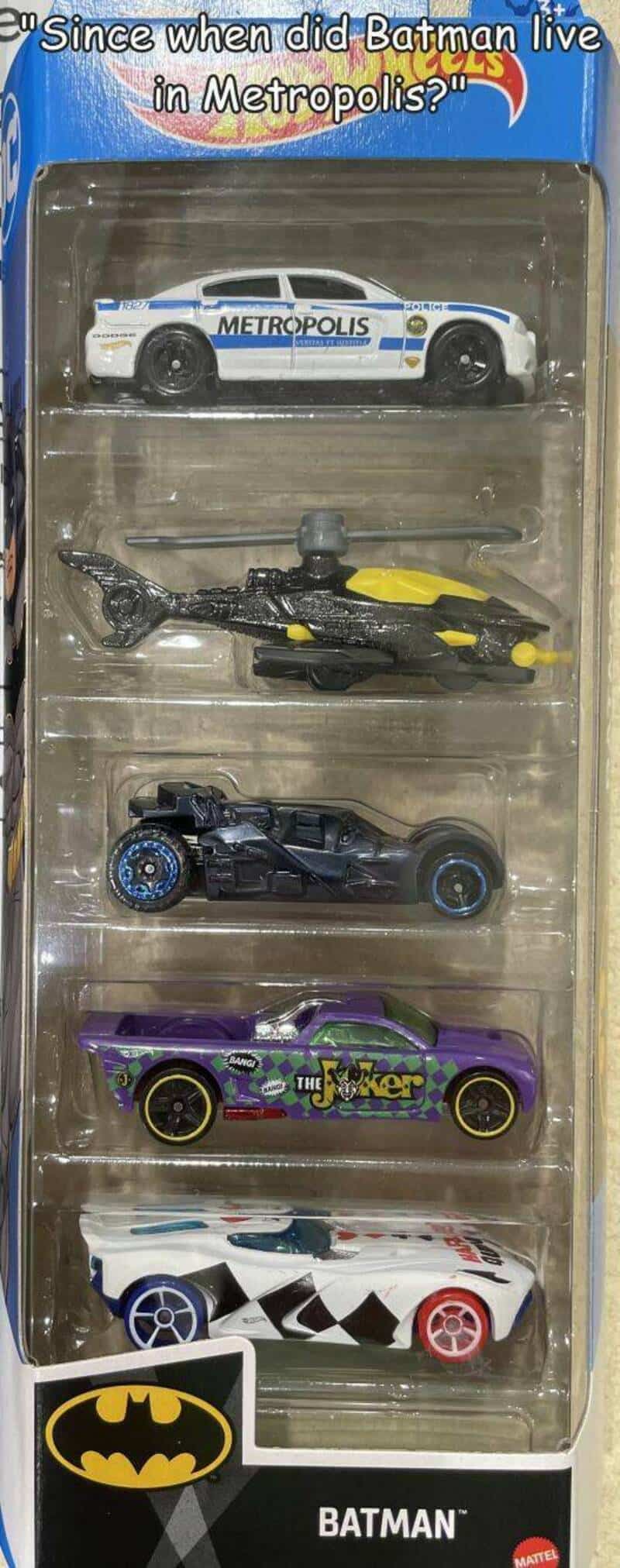 Collection of five Batman-themed toy vehicles in packaging, with a quote about Batman in Metropolis.