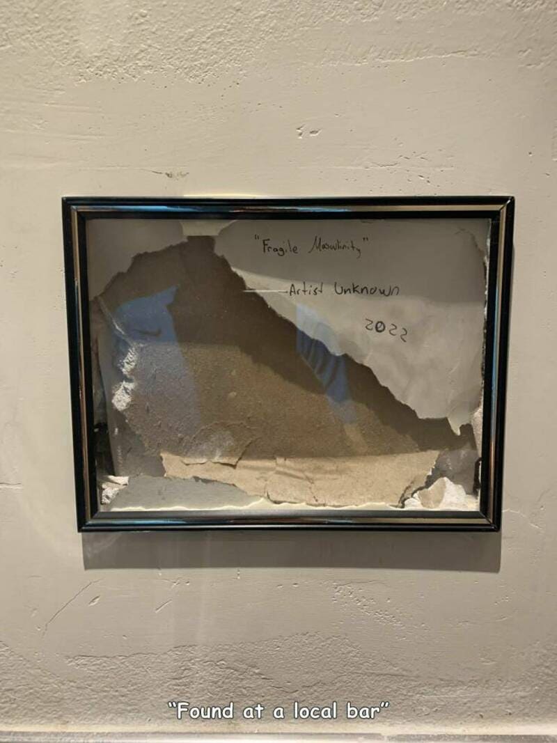 Torn picture frame with handwritten note 'Fragile Mouths' and 'Artist Unknown 2022'.