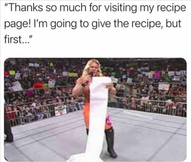 Wrestler holding a long paper towel roll in the ring.