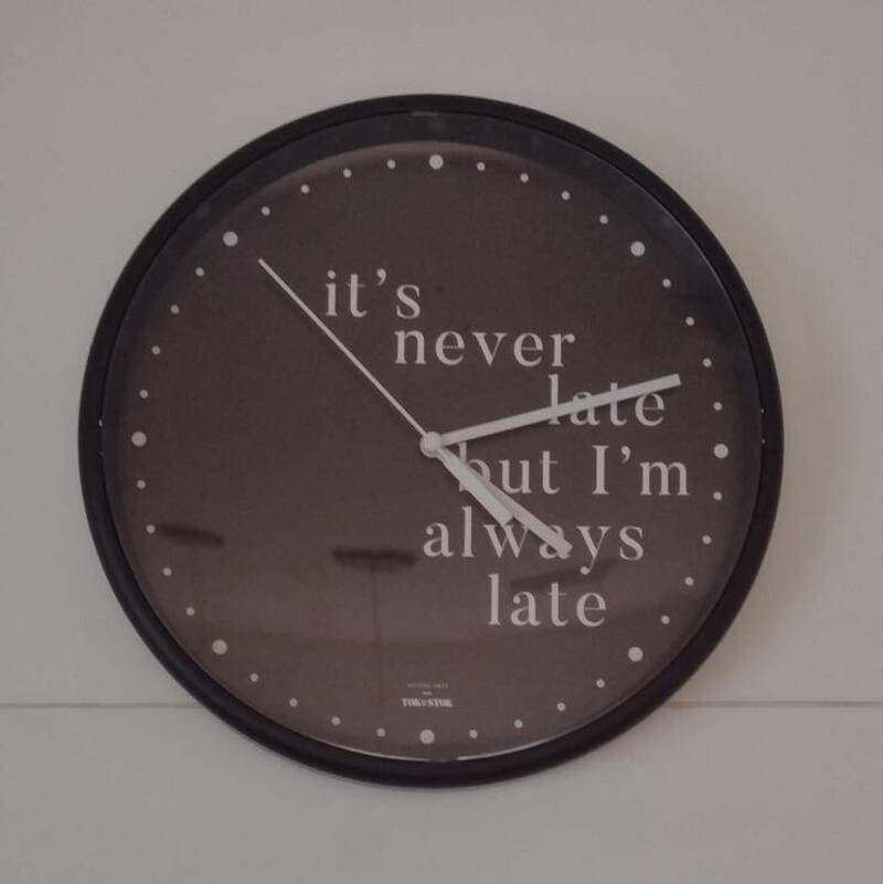 Clock with the phrase 'it's never late but I'm always late' on the face.