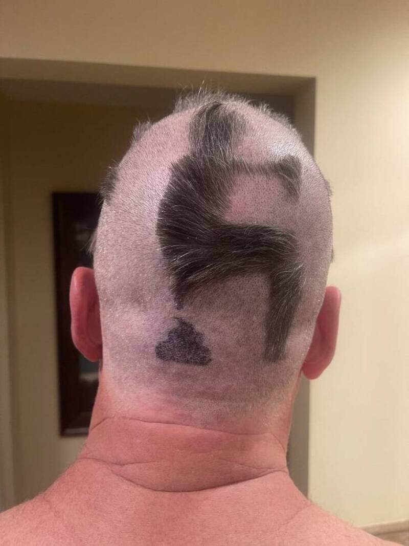 Haircut with a design of a face and a hat on the back of the head.