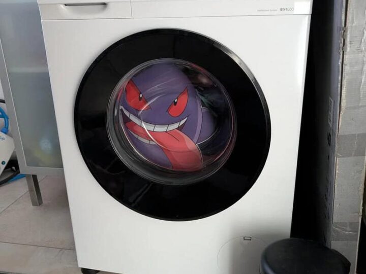 Washing machine with a Gengar Pokémon sticker on the door.