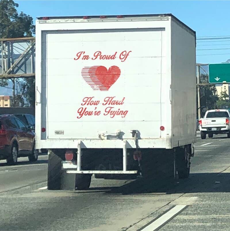 Truck with a sign saying 'I'm Proud Of Heart How Hard You're Trying'.