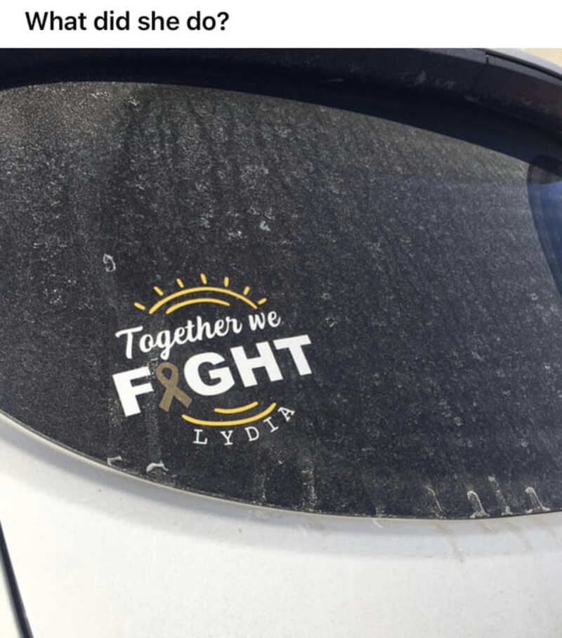 Sticker on car window reading 'Together we FIGHT Lydia' with sun illustration.