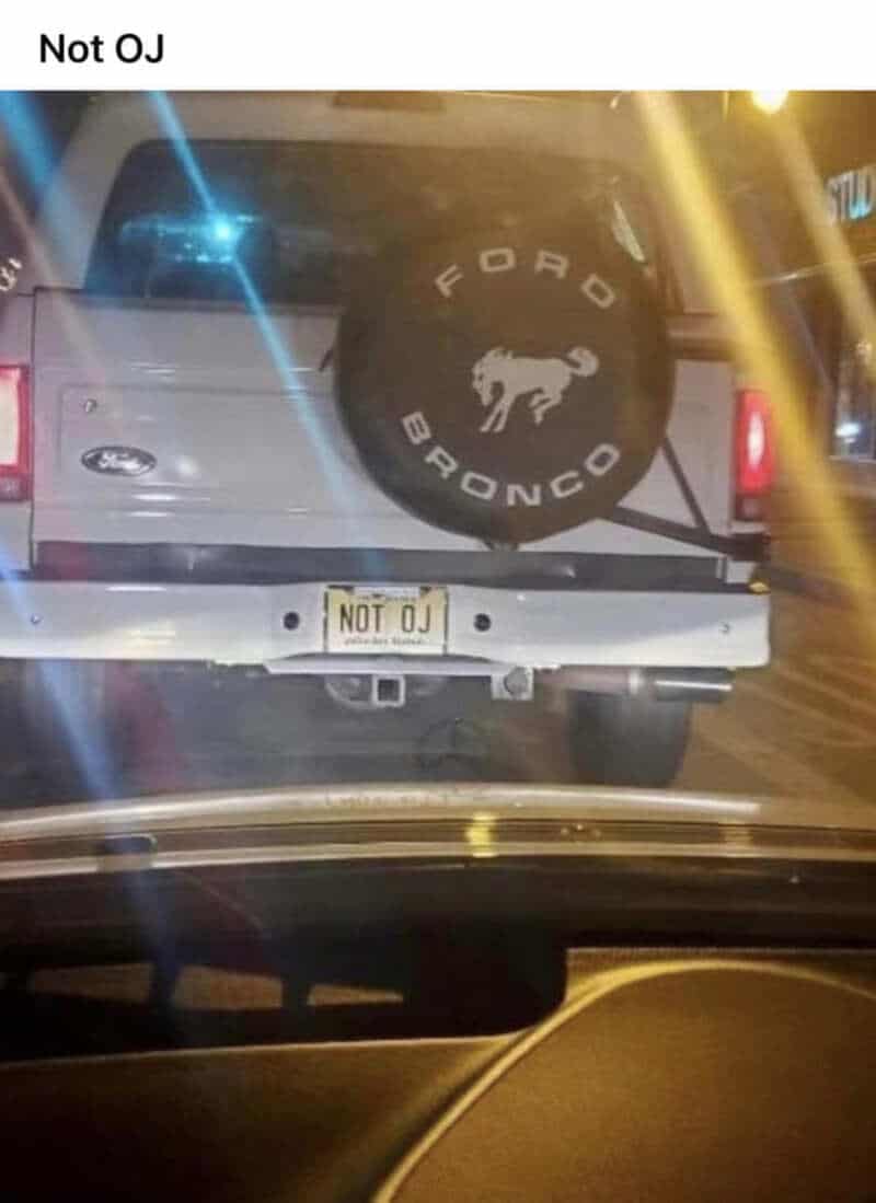 Ford Bronco with a spare tire cover featuring a buffalo logo and a custom license plate reading 'NOT.