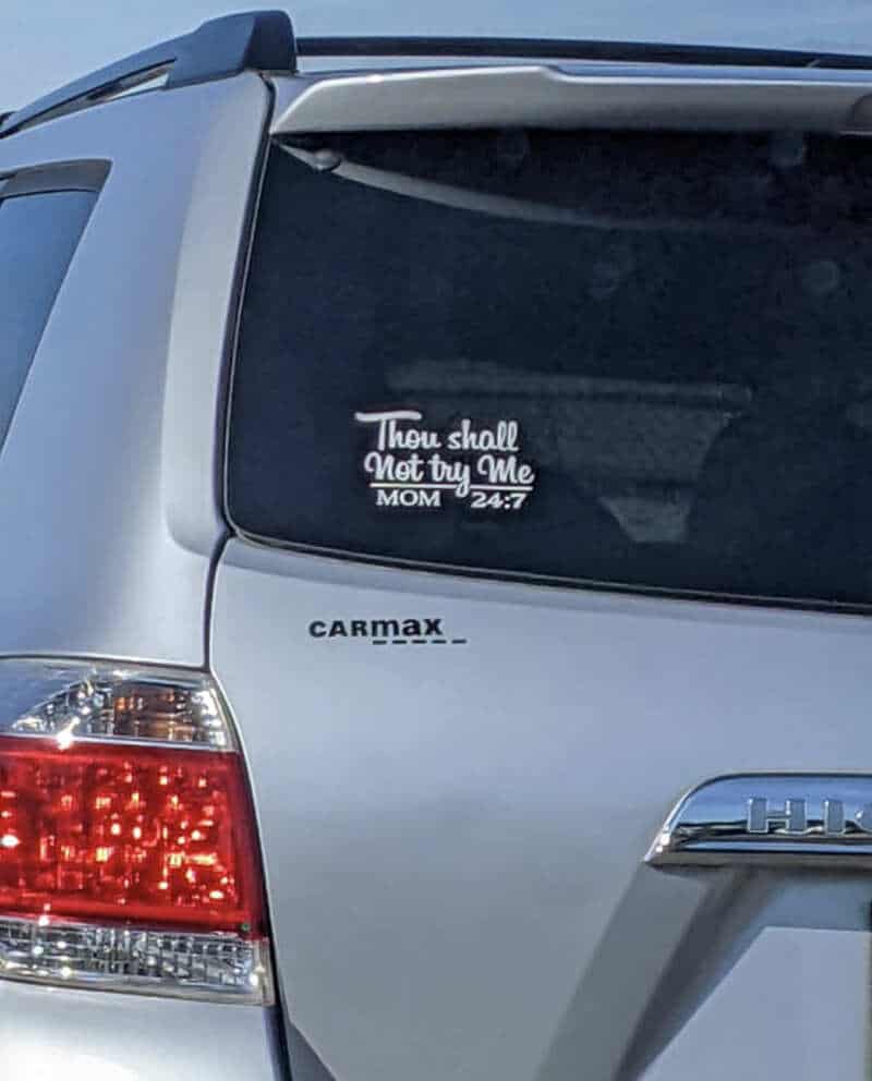 Car window decal says 'Thou shall not try Me MOM 24:7'.