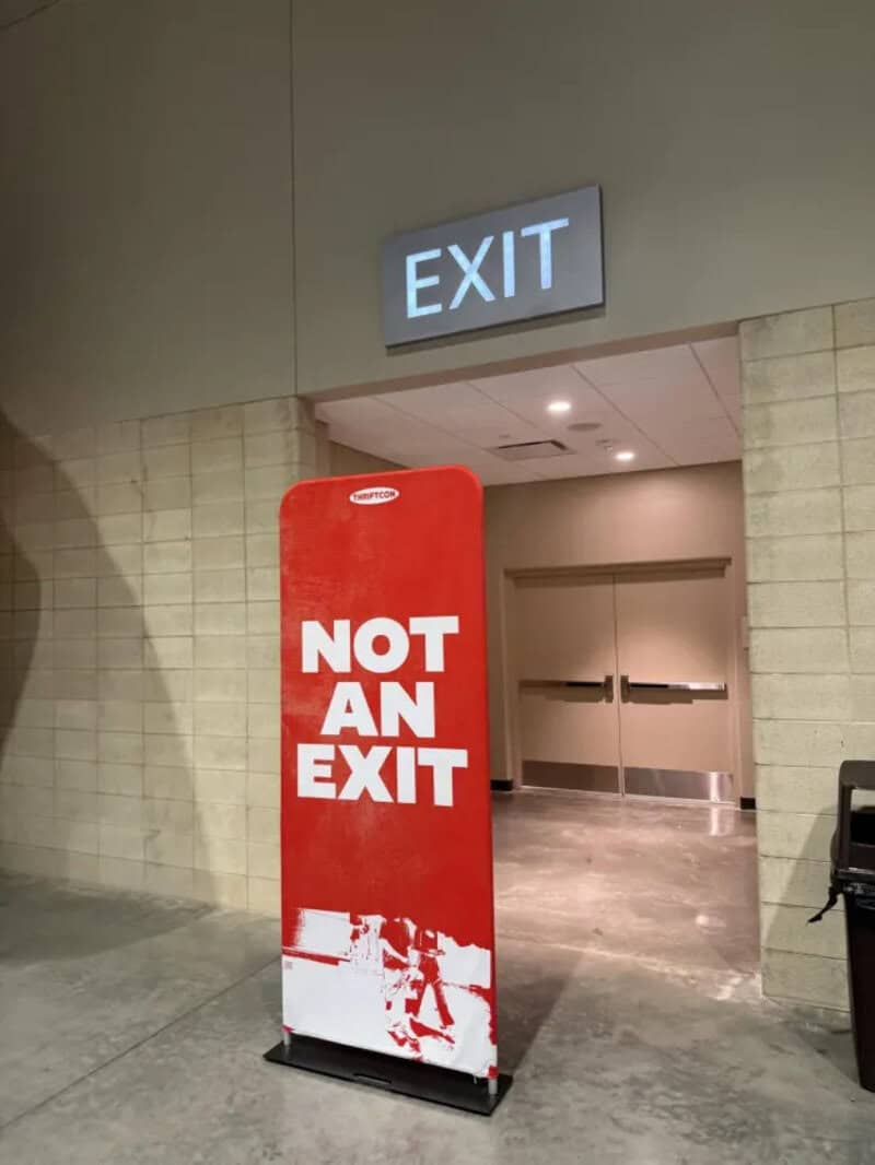 Red sign says 'NOT AN EXIT' in front of an exit door.