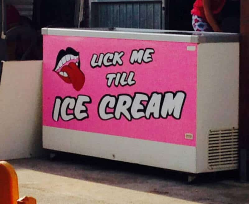 Sign says 'LICK ME TILL ICE CREAM' with a tongue and lips graphic.