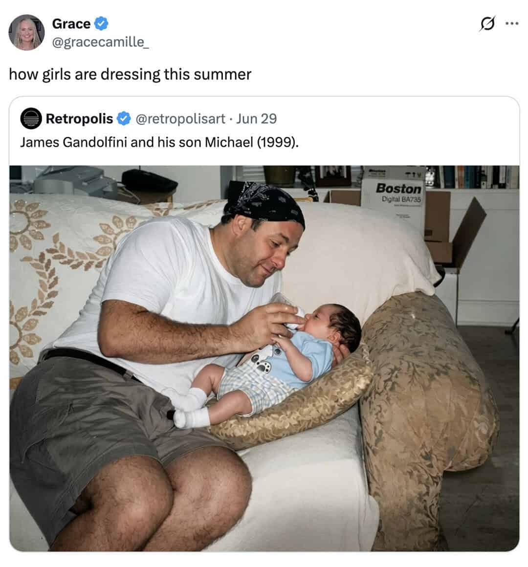 A man and a baby sitting on a couch, with the man holding the baby.