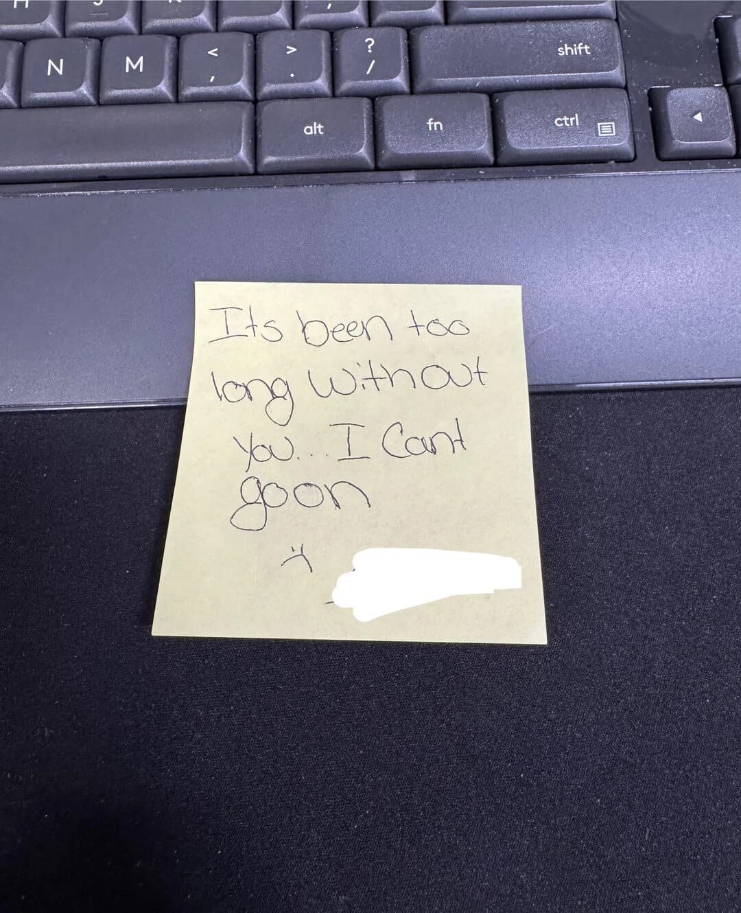 Note on a keyboard saying 'It's been too long without you. I can’t'.