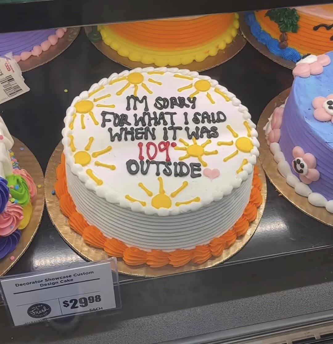Cake with sun designs and funny message about outdoor activity.