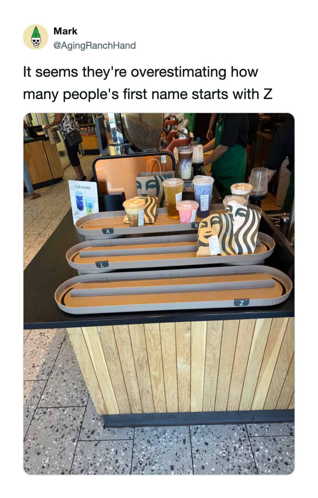 Starbucks drinks and food on a counter with a Z-shaped sign.