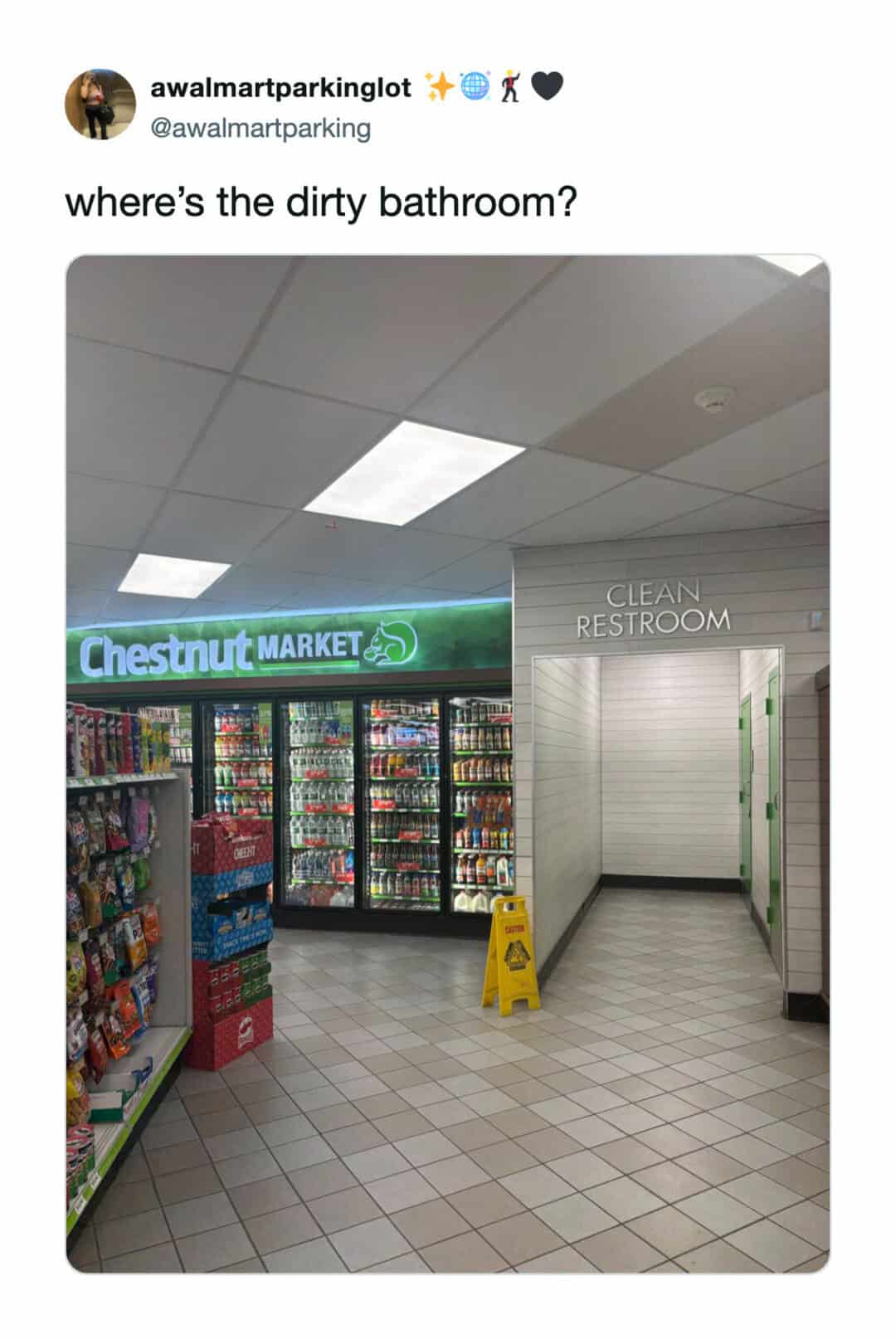 Store aisle with a clean restroom sign and a yellow caution sign on the floor.