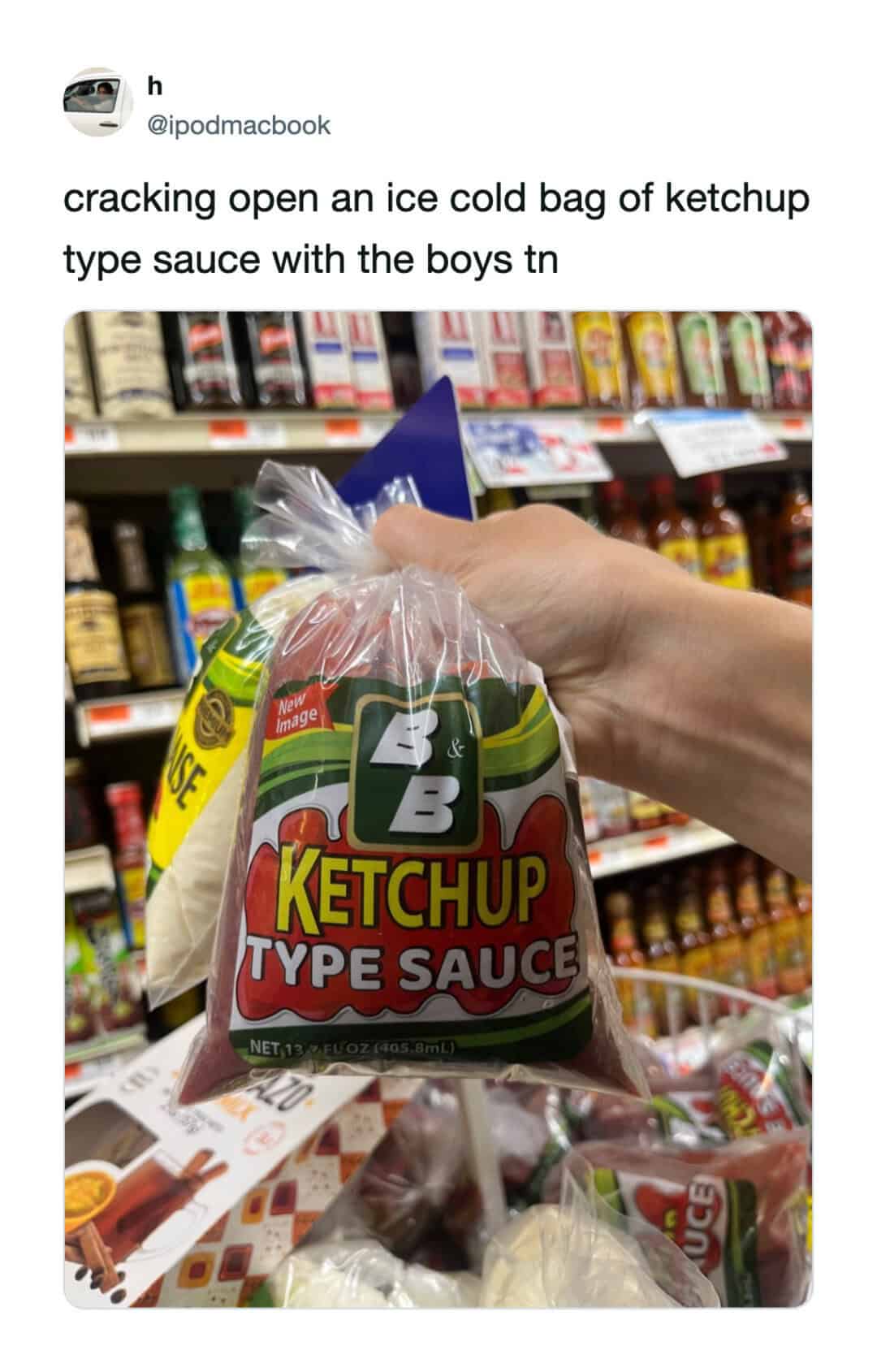 Hand cracking open a ketchup packet in a grocery store.