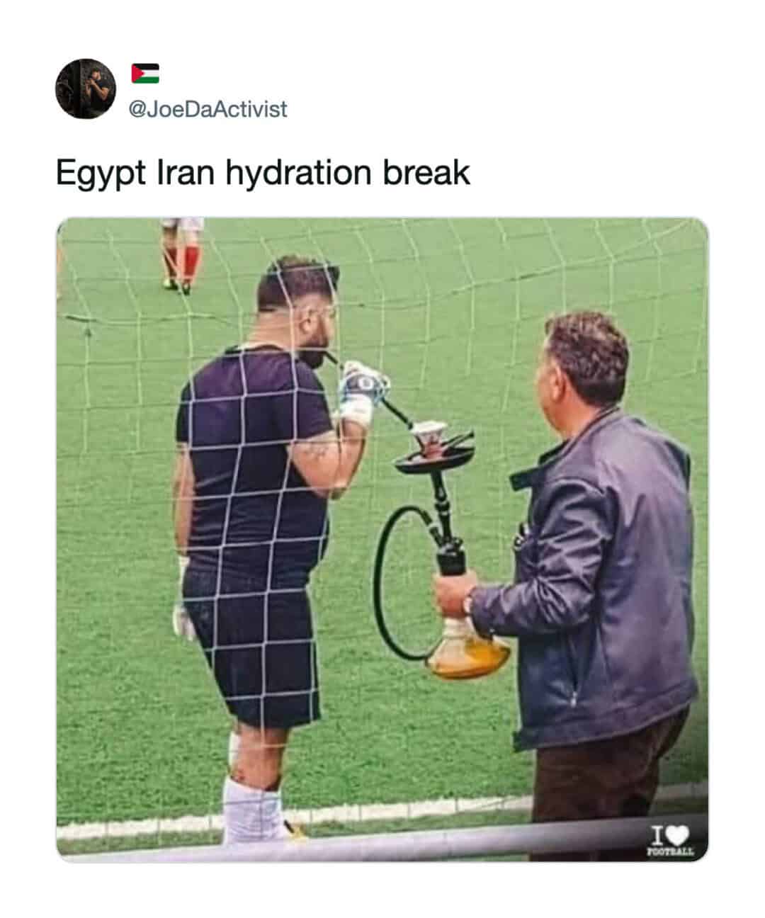 Football player receiving water from a man with a hookah on the sideline.
