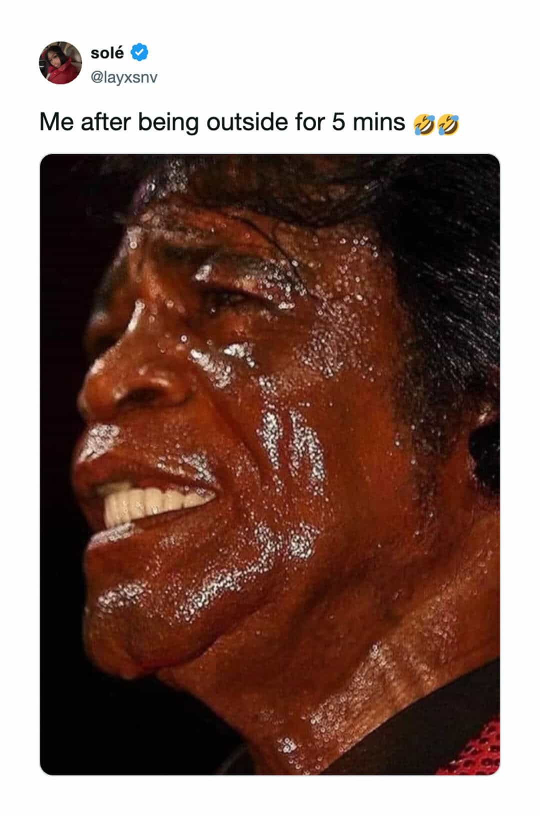 Person sweating heavily after being outside for 5 minutes, smiling.