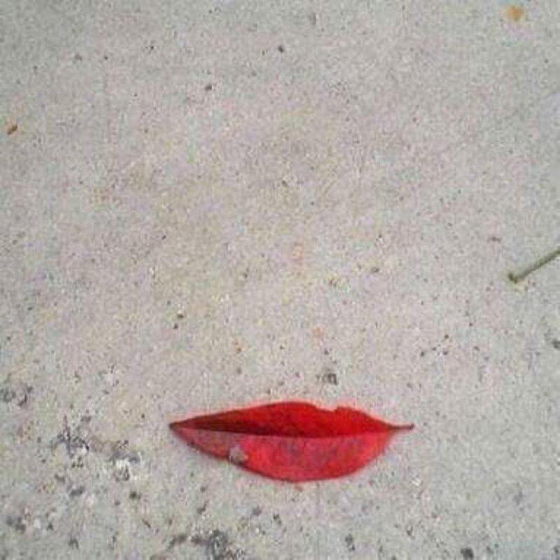 Red lipstick mark on a light-colored surface.