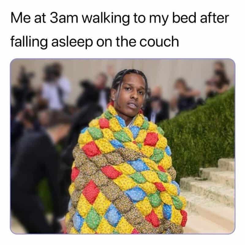 Person wrapped in colorful blanket with a tired expression, at 3am.
