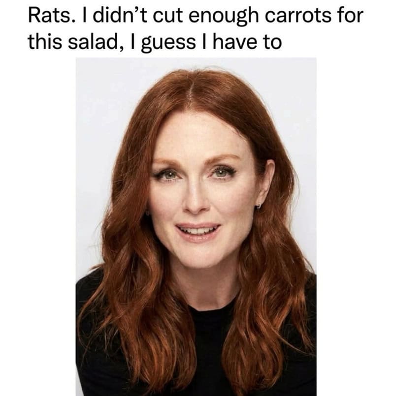 Red-haired woman with a slight smile, wearing a black top, with text above her head.