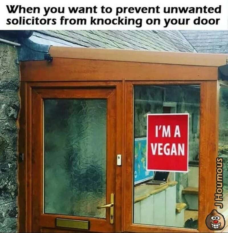 Door with a sign saying 'I'm a vegan' to prevent solicitors from knocking.