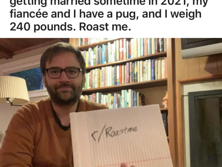 Dan Wilbur writer and comedian holding roast me sign and informing people he owns a pug and weighs 240 pounds