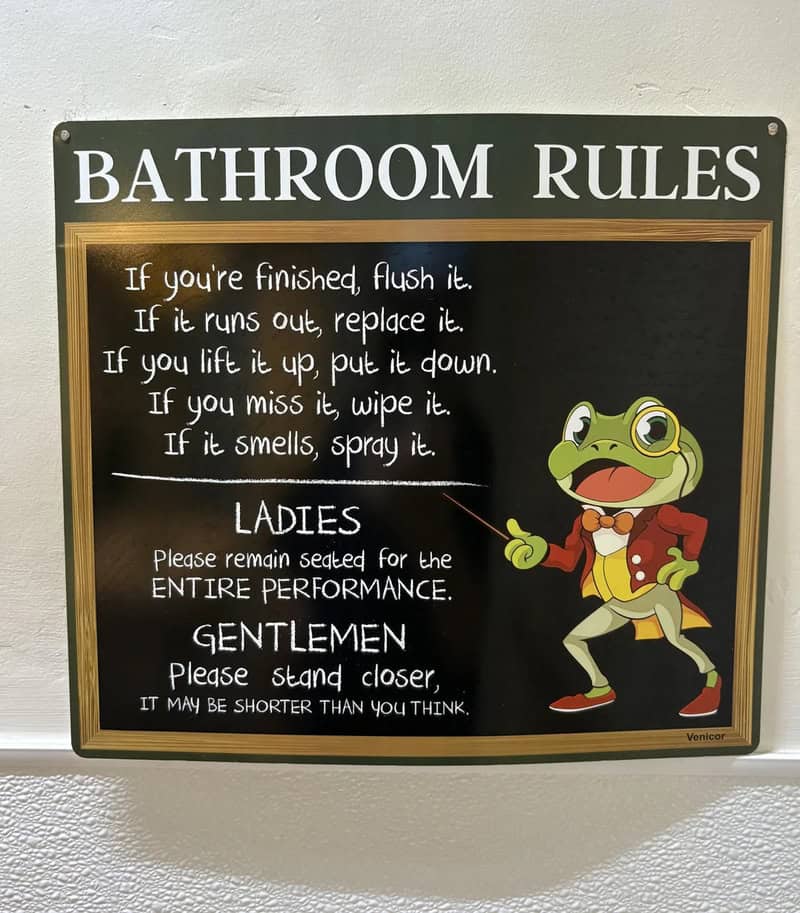 Bathroom rules chalkboard with frog mascot and humorous instructions for ladies and gentlemen.