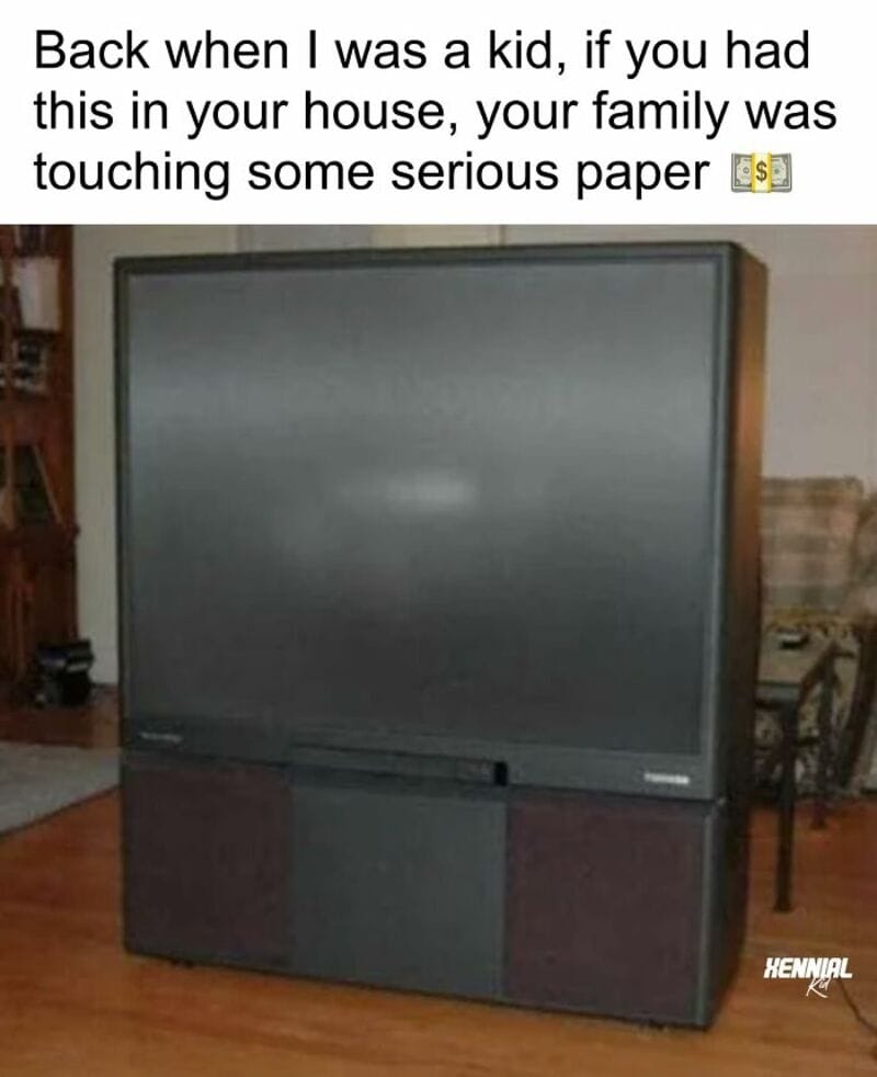 A large flat-screen TV with a wooden frame and a soundbar below it.