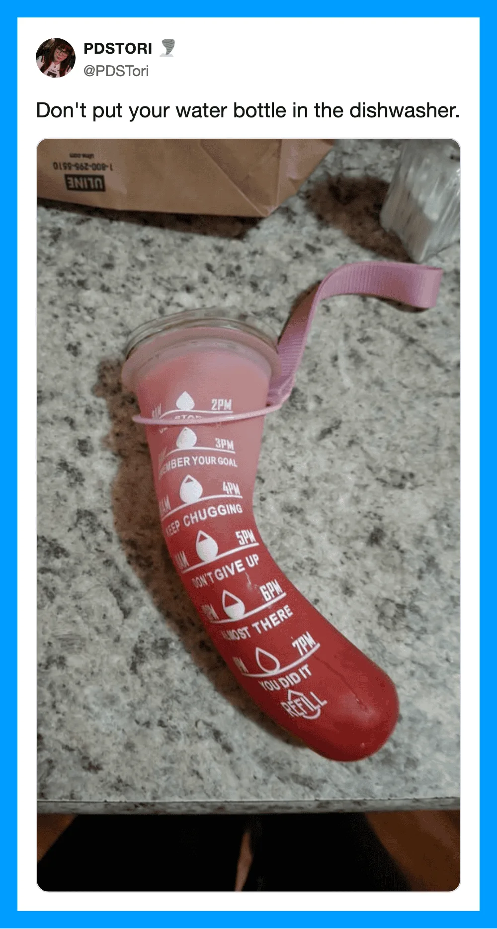 Water bottle shaped like a Christmas stocking with a pink straw.