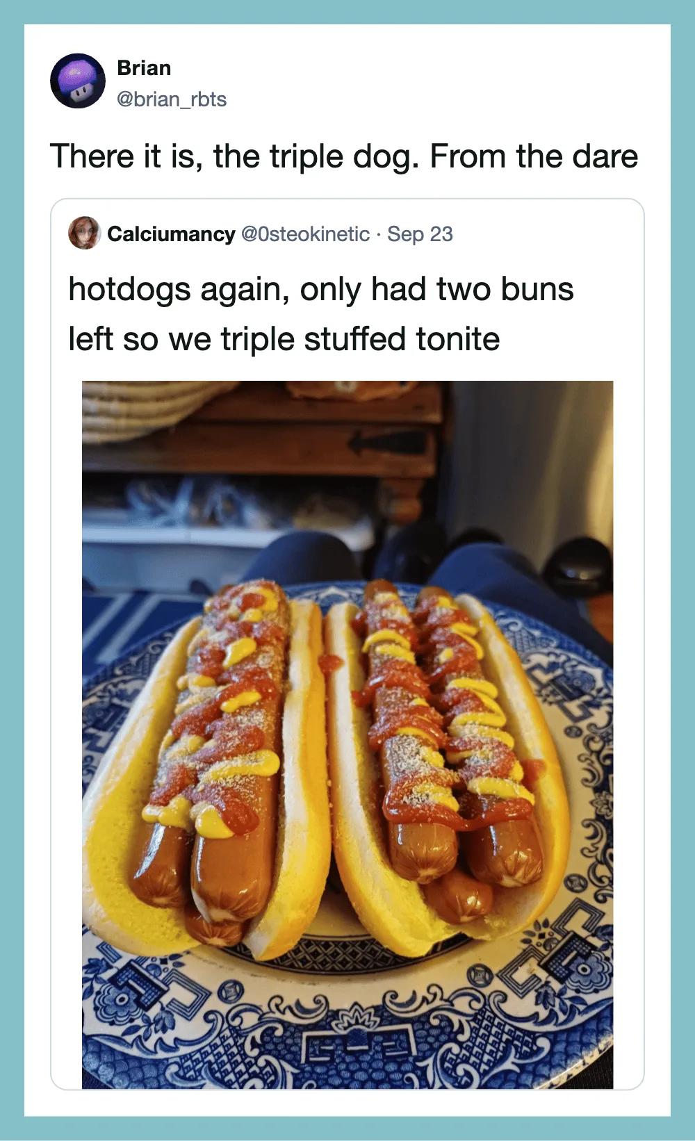 Three hotdogs in buns with toppings on a blue patterned plate.