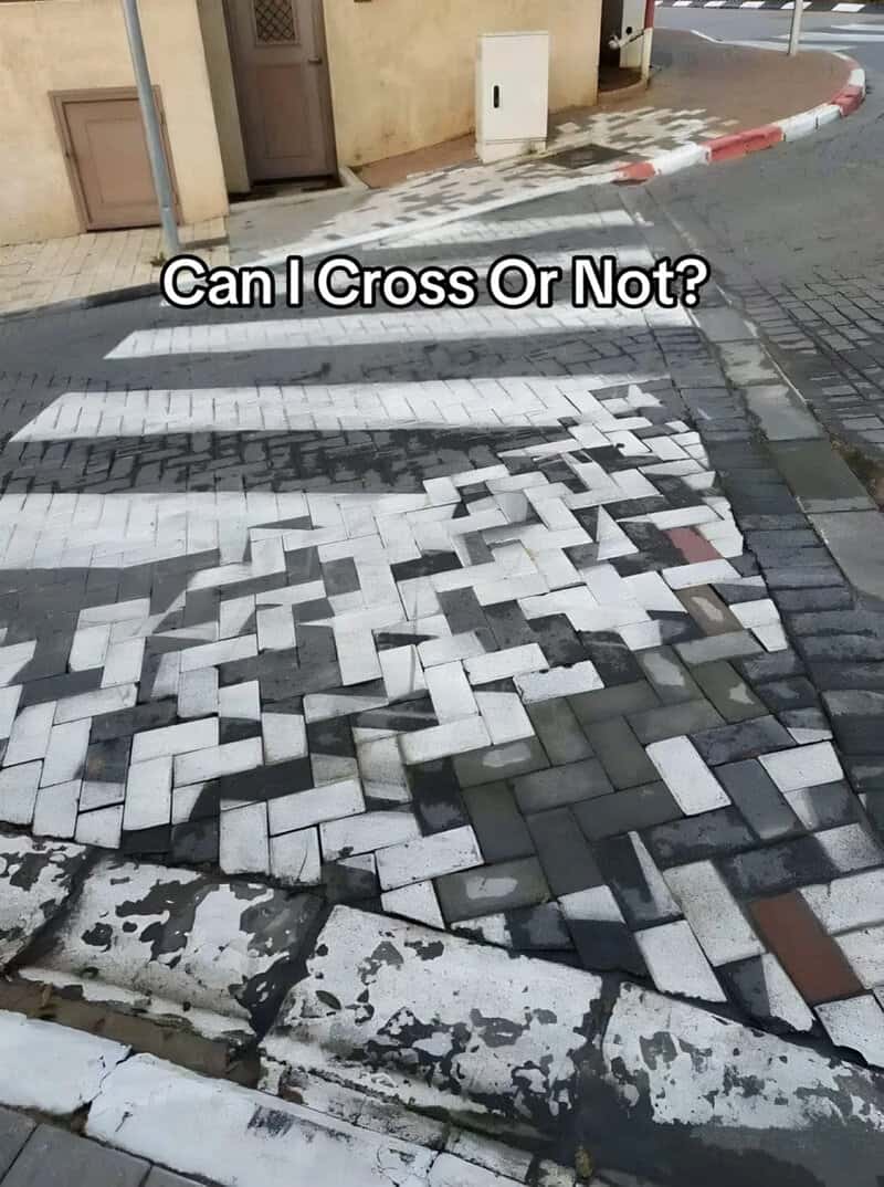 Can I Cross Or Not? Confusing and damaged crosswalk tiles on the street.