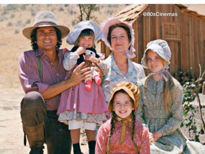 Family in vintage clothing outdoors with a wooden house, caption about dinner instead of door dash.
