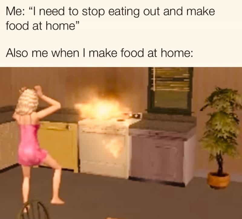 Person in pink dress causing a fire in the kitchen while cooking at home.