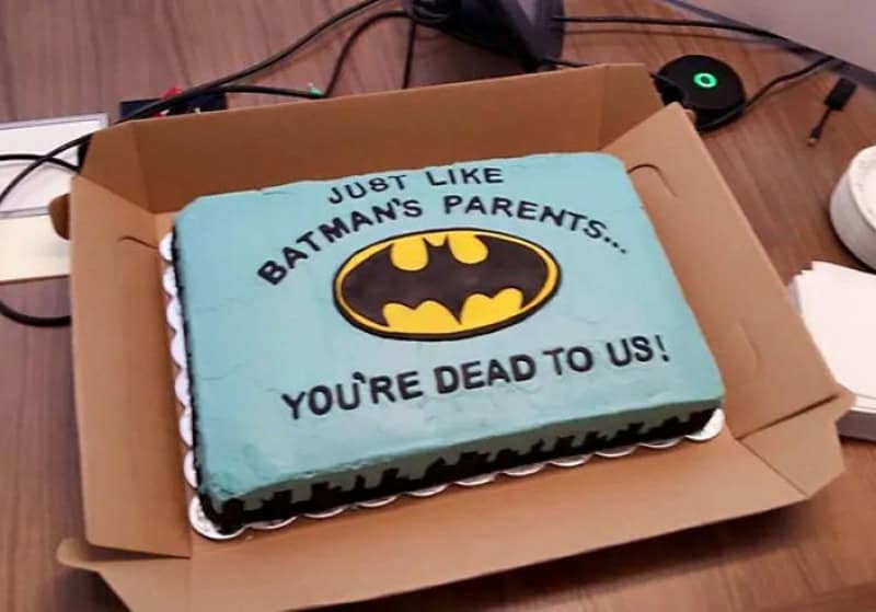 Batman-themed cake with the message 'Just like Batman's parents... You're dead to us!'.