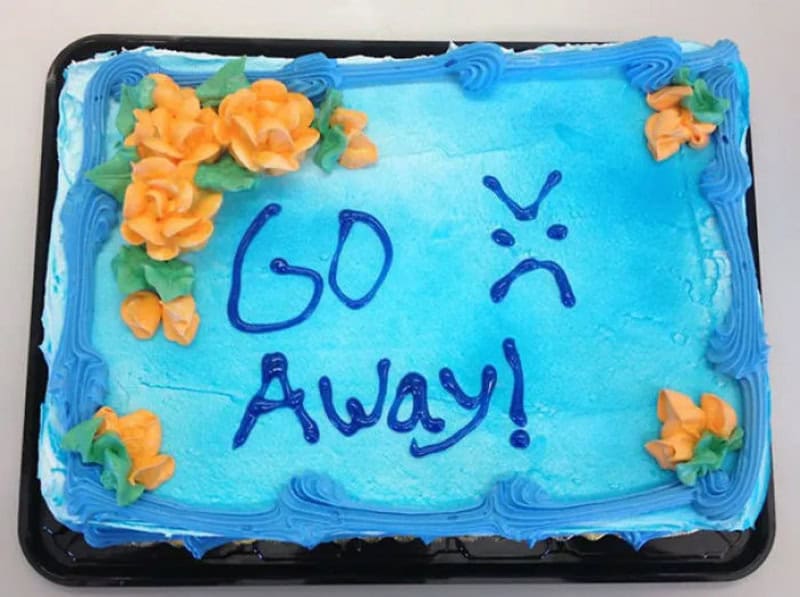 Blue farewell cake with orange flowers and 'Go Away!' written in blue icing.
