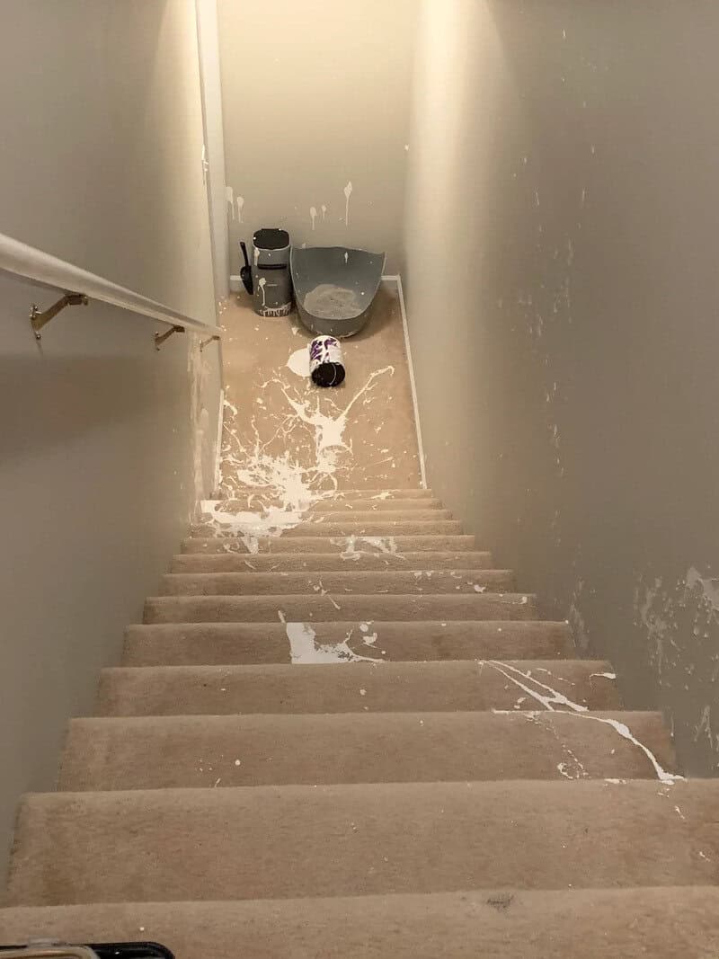 Clumsy spill on staircase with cleaning supplies at the top.