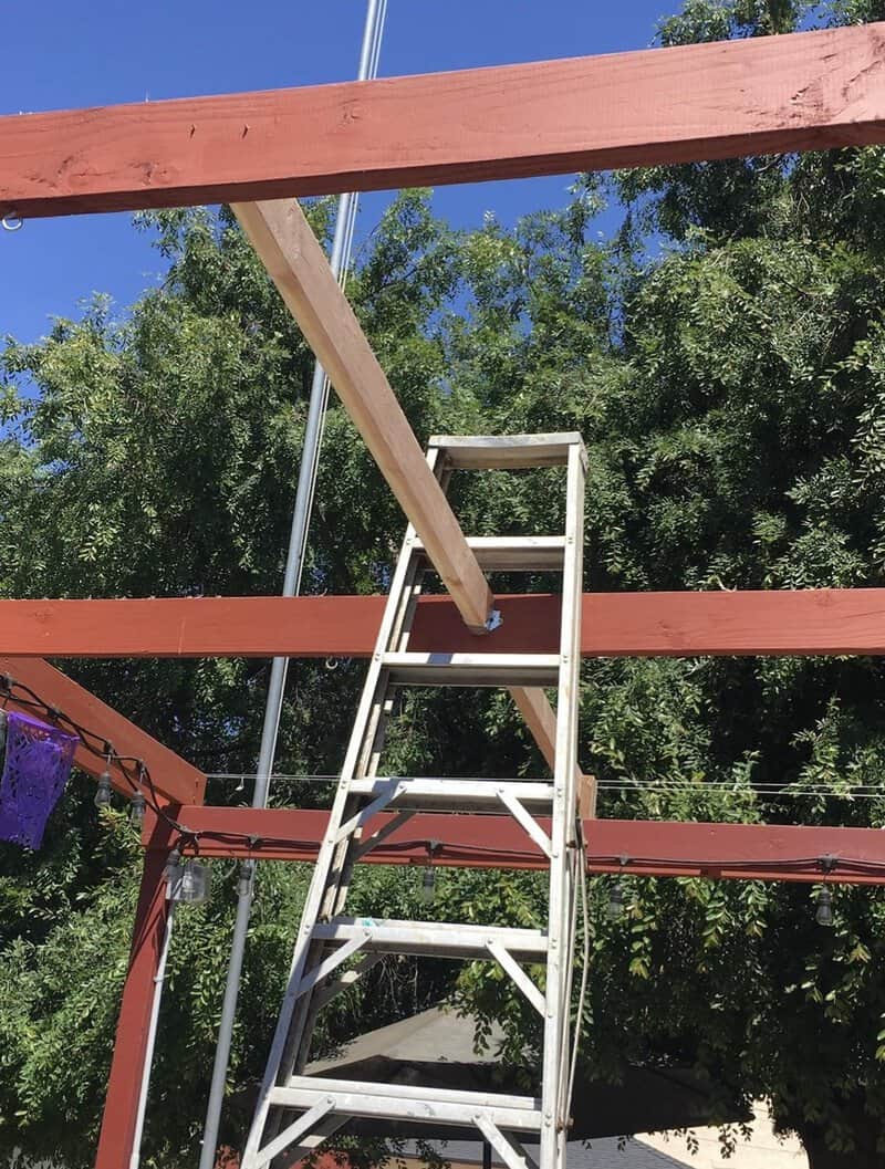 Ladder leaning against a wooden beam during home improvement work.