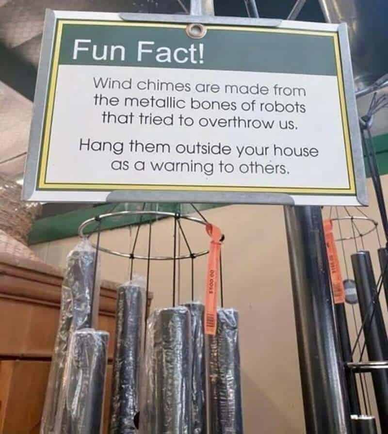 Sign about wind chimes made from robot bones, jokingly suggesting hanging them outside as a warning.