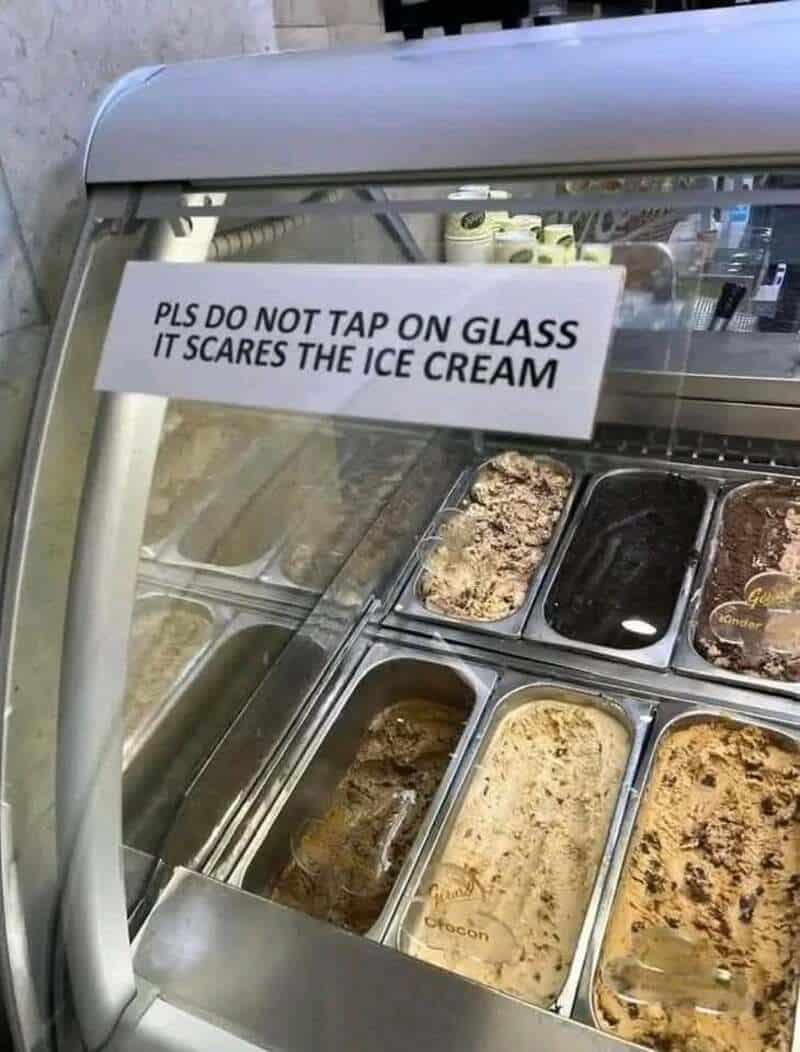 Sign on ice cream display: 'PLS DO NOT TAP ON GLASS IT SCARES THE ICE CREAM'.