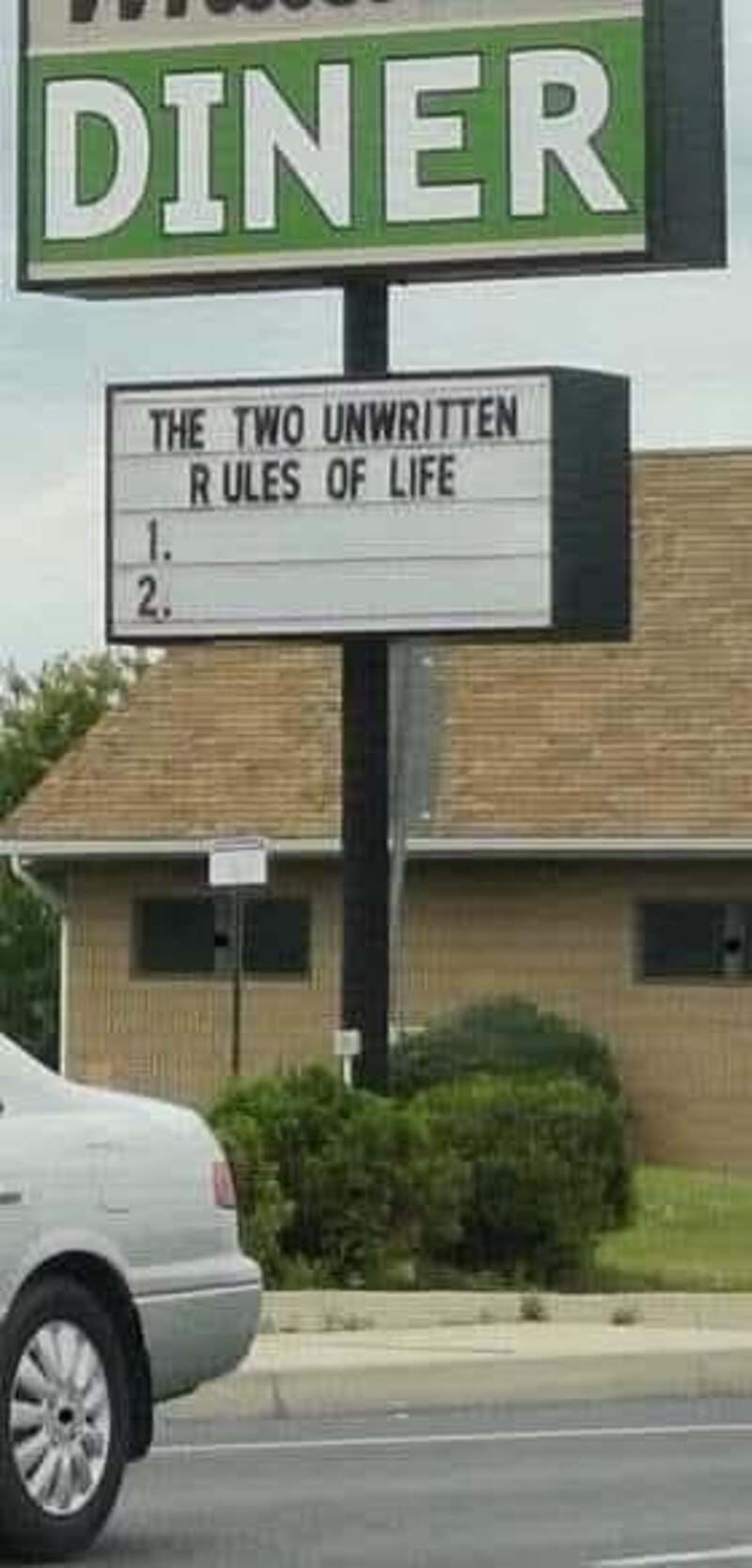 Sign at a diner with 'The Two Unwritten Rules of Life' and two blank lines.