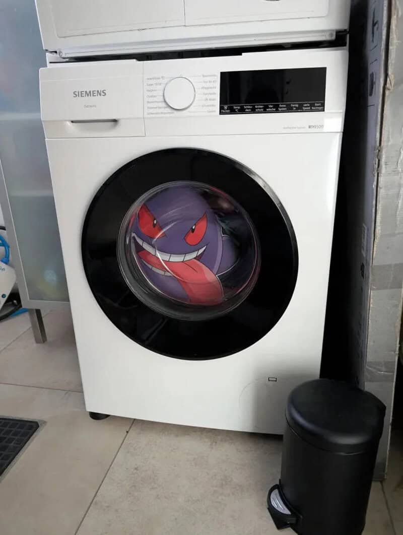 Washing machine with a Gengar Pokémon sticker on the door.